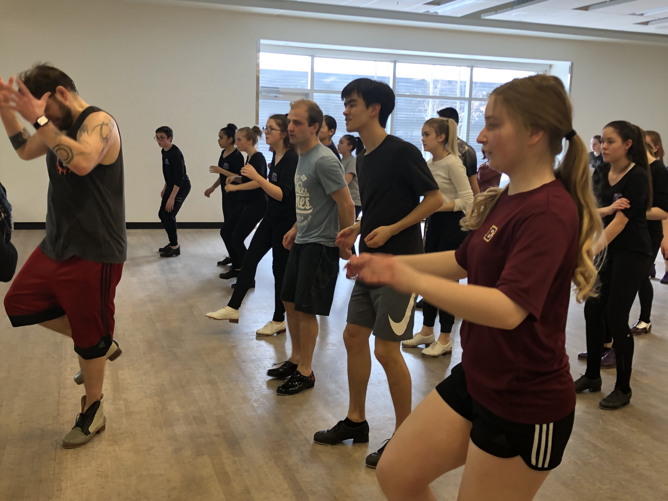 Group practicing dance steps in studio